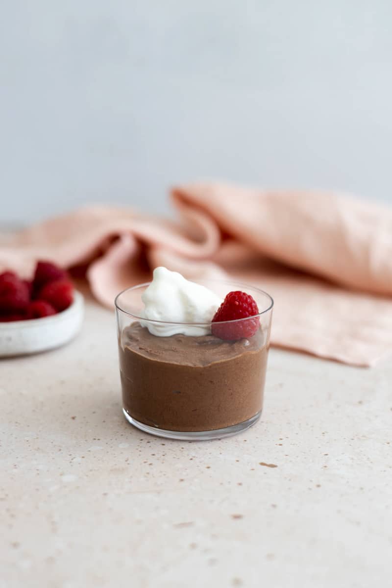 A raspberry added to the chocolate mousse.