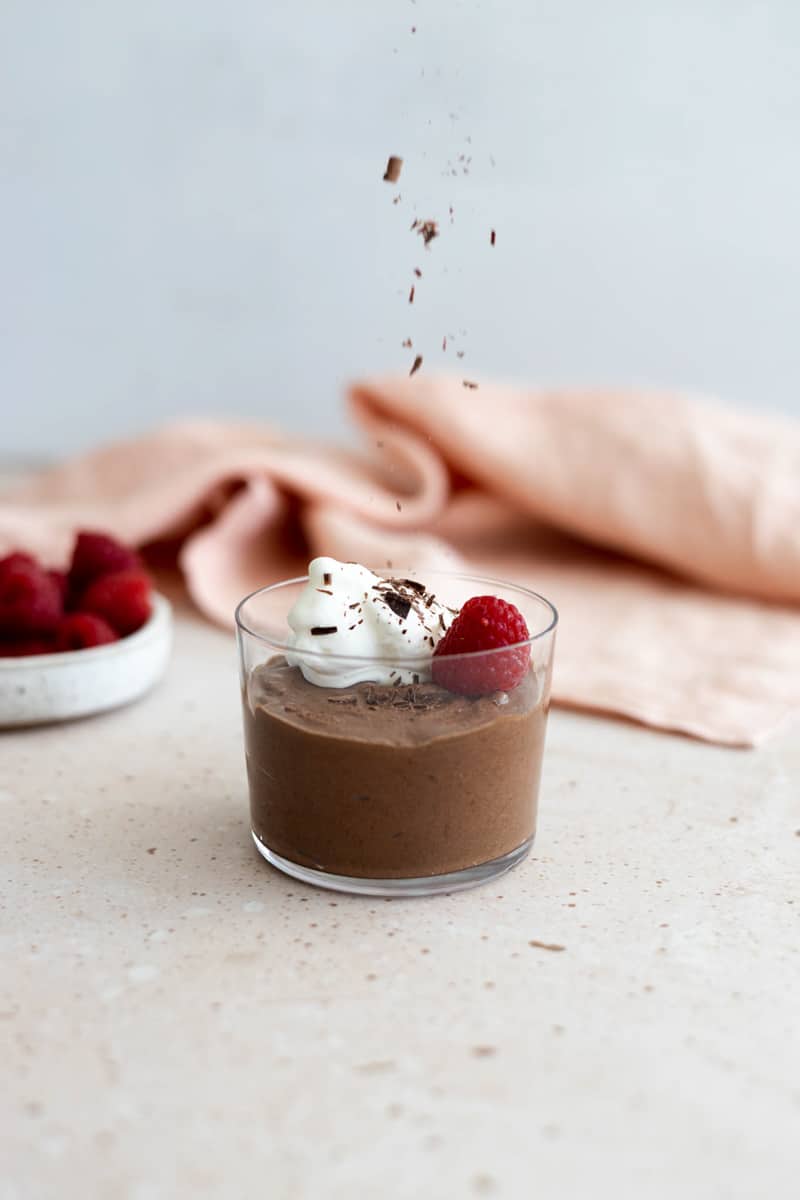 Chocolate shavings being sprinkled on the chocolate mousse.