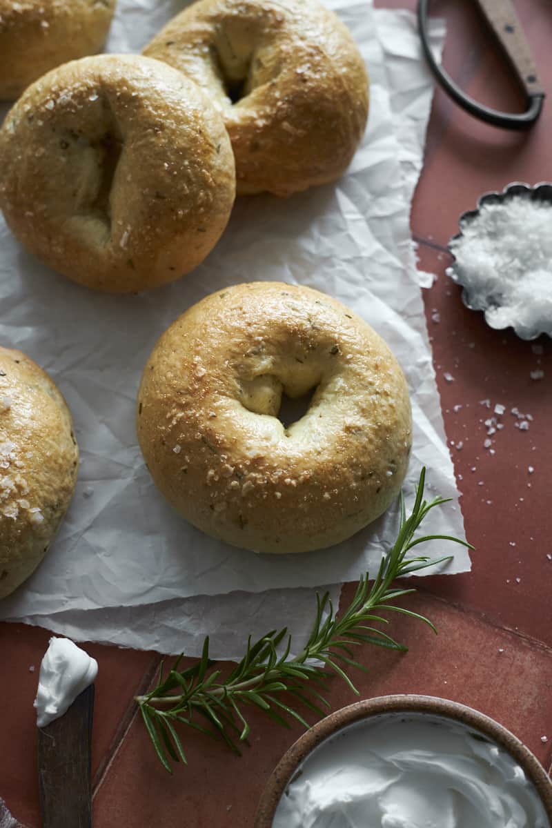 Rosemary Bagels on white parchment paper.