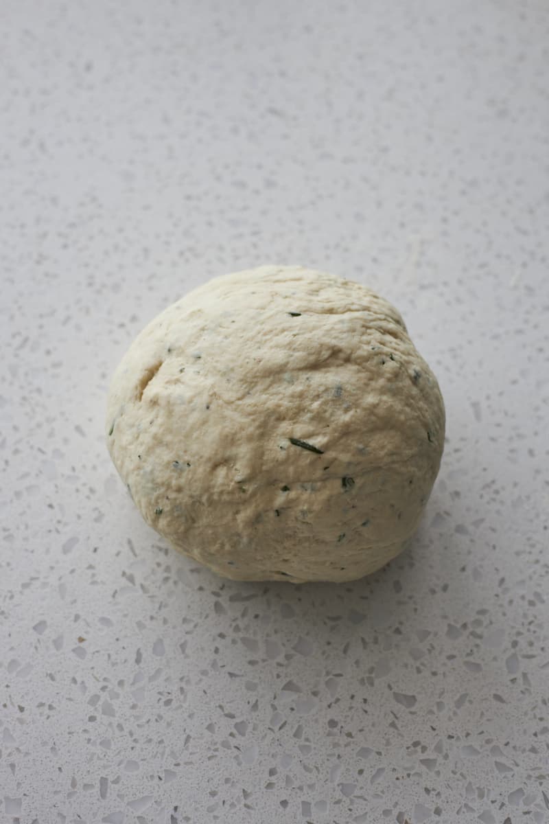 Smooth dough on work surface after kneading.