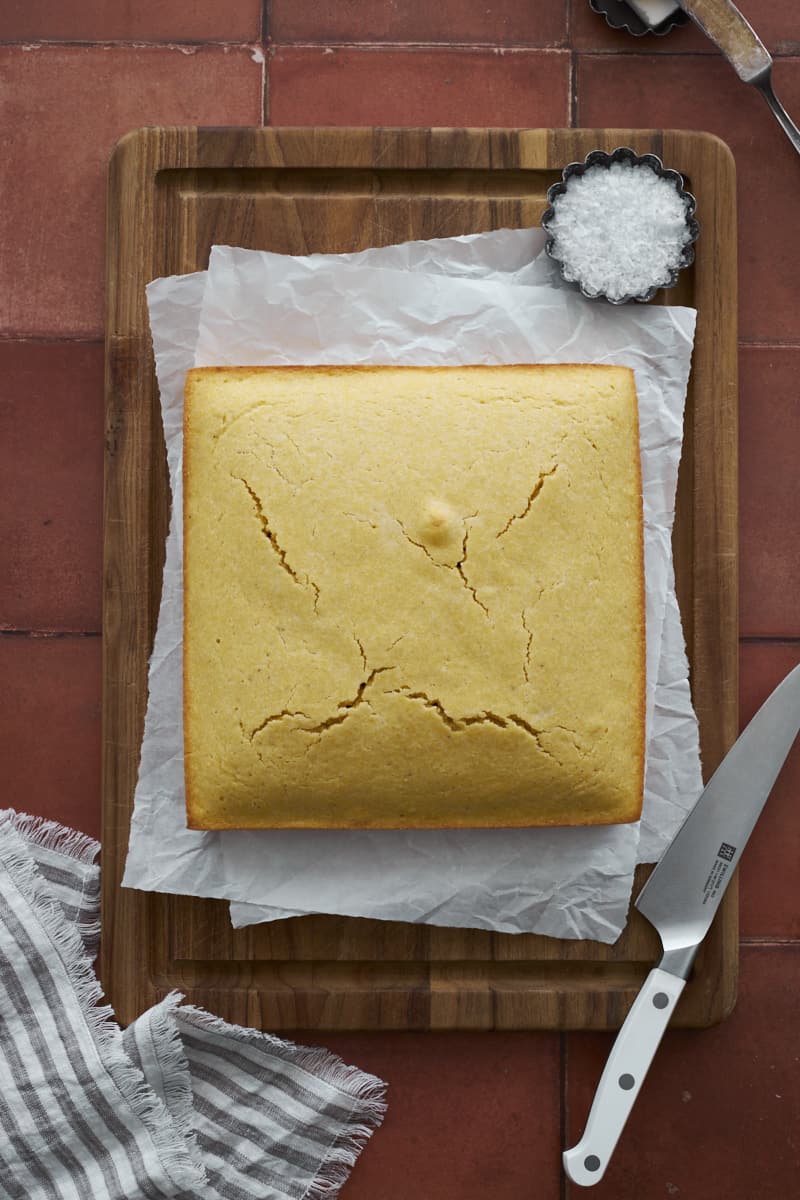 Baked cornbread on a cutting board.