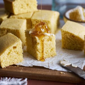 Sourdough Discard Cornbread topped with butter and honey.