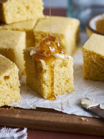 Sourdough Discard Cornbread topped with butter and honey.