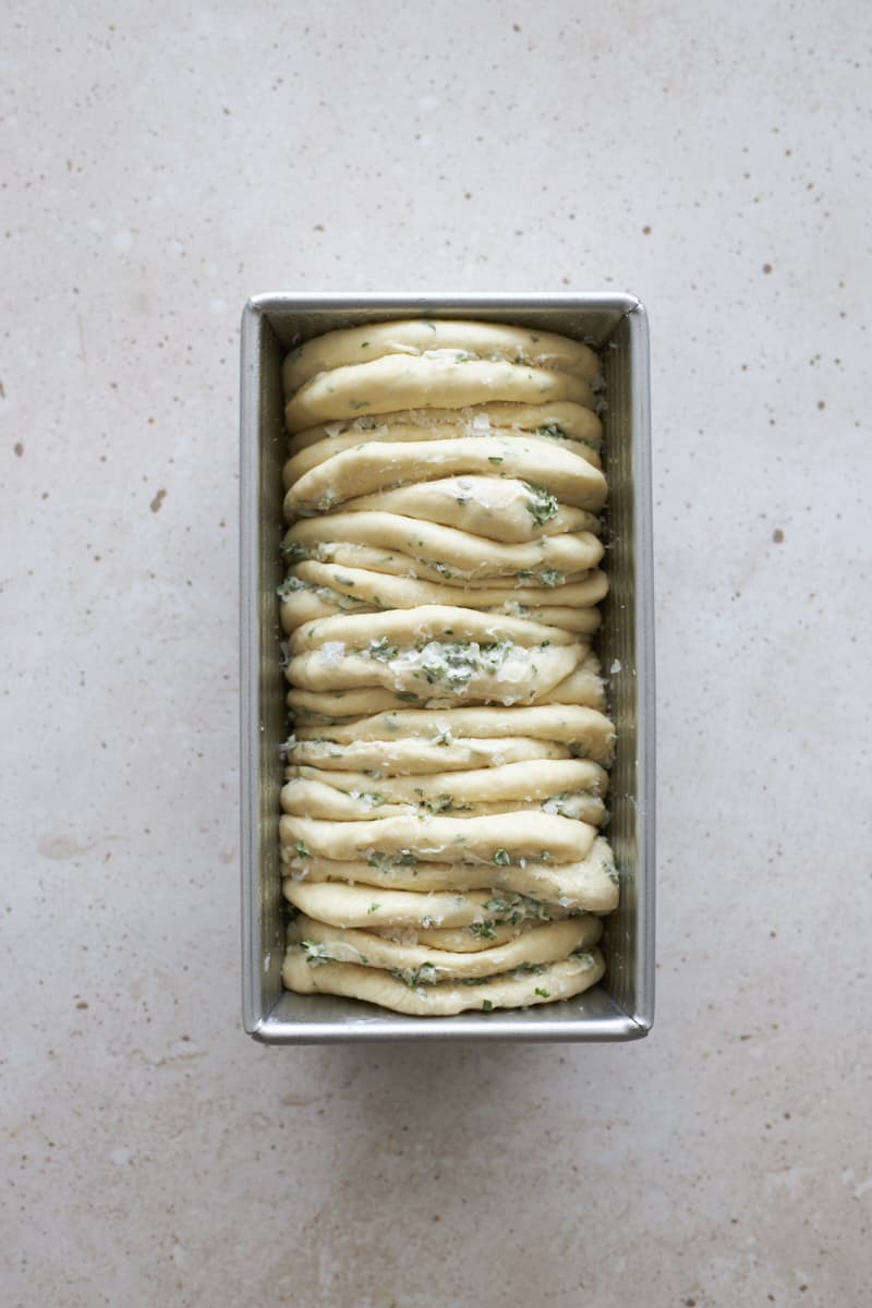 Sourdough Discard Garlic Pull Apart Bread in the bread pan ready to bake.