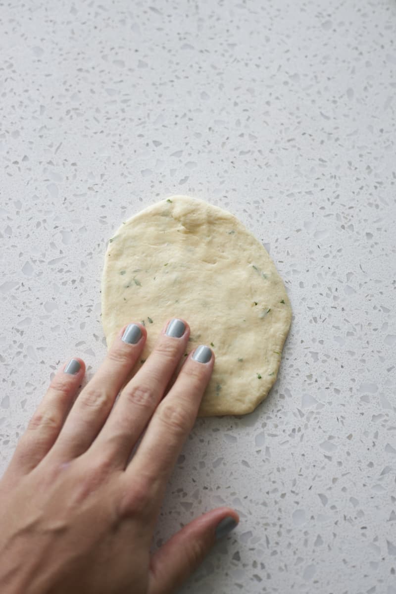 Dough pressed into a small, flat circle.