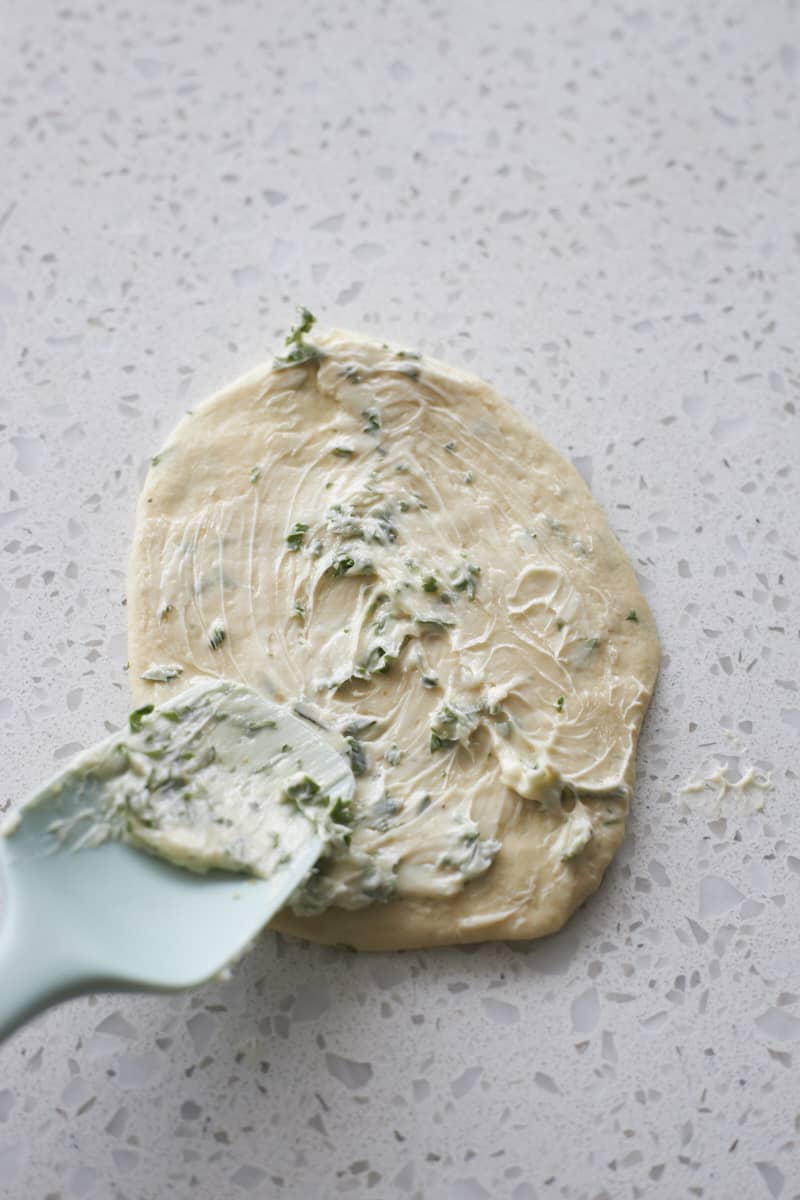 Dough spread with butter mixture.