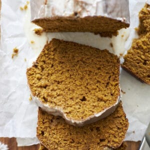 Slices of Sourdough Discard Pumpkin Bread on a wooden cutting board.