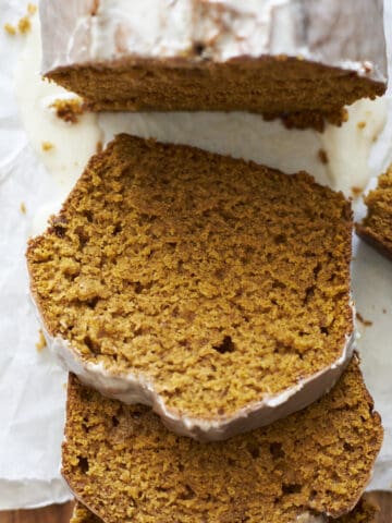 Slices of Sourdough Discard Pumpkin Bread on a wooden cutting board.