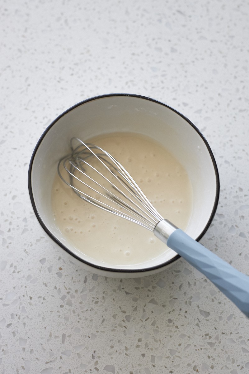 Glaze whisked in a small white bowl.