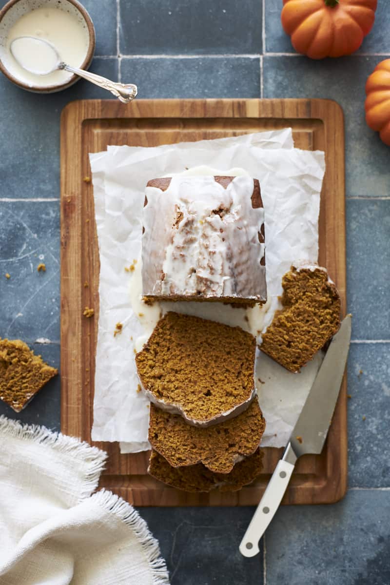 Sliced Sourdough Discard Pumpkin Bread on a wooden cutting board.