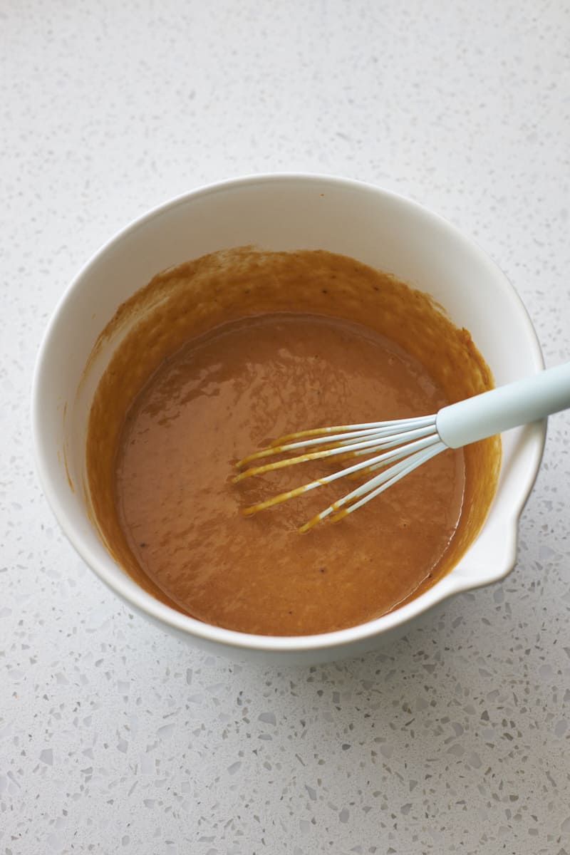 Wet ingredients mixed in a large mixing bowl.