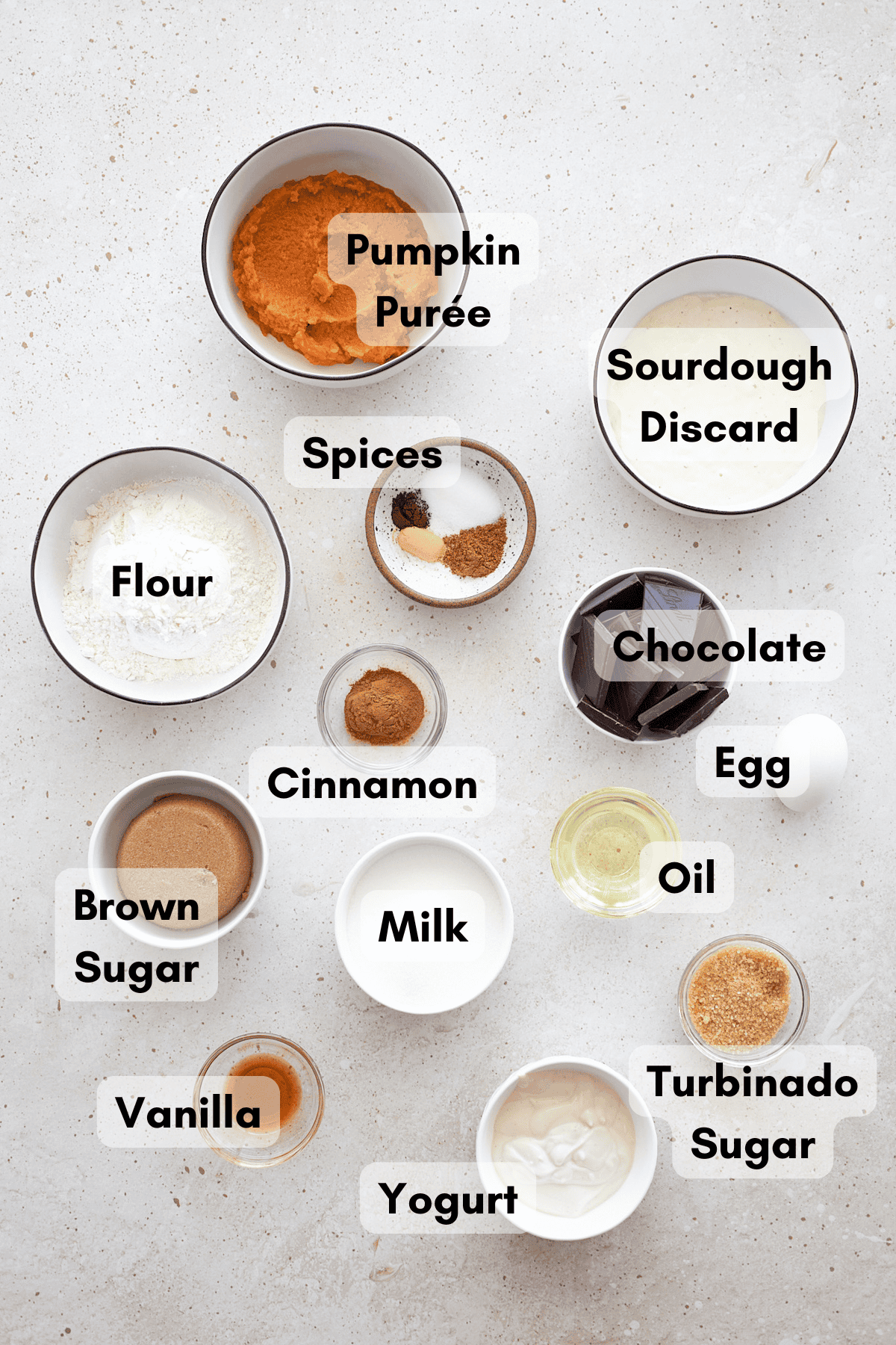 Ingredients for Sourdough Discard Pumpkin Chocolate Chunk Bread in small bowls. 