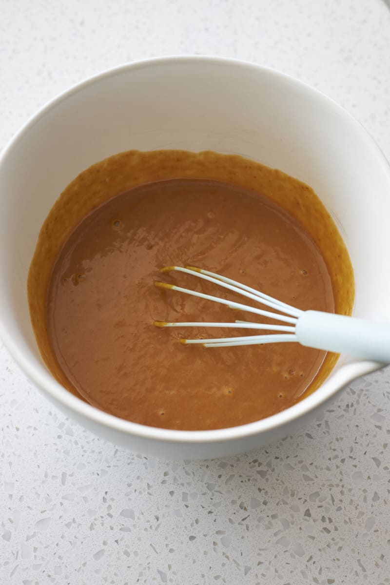 Wet ingredients mixed together in a mixing bowl.