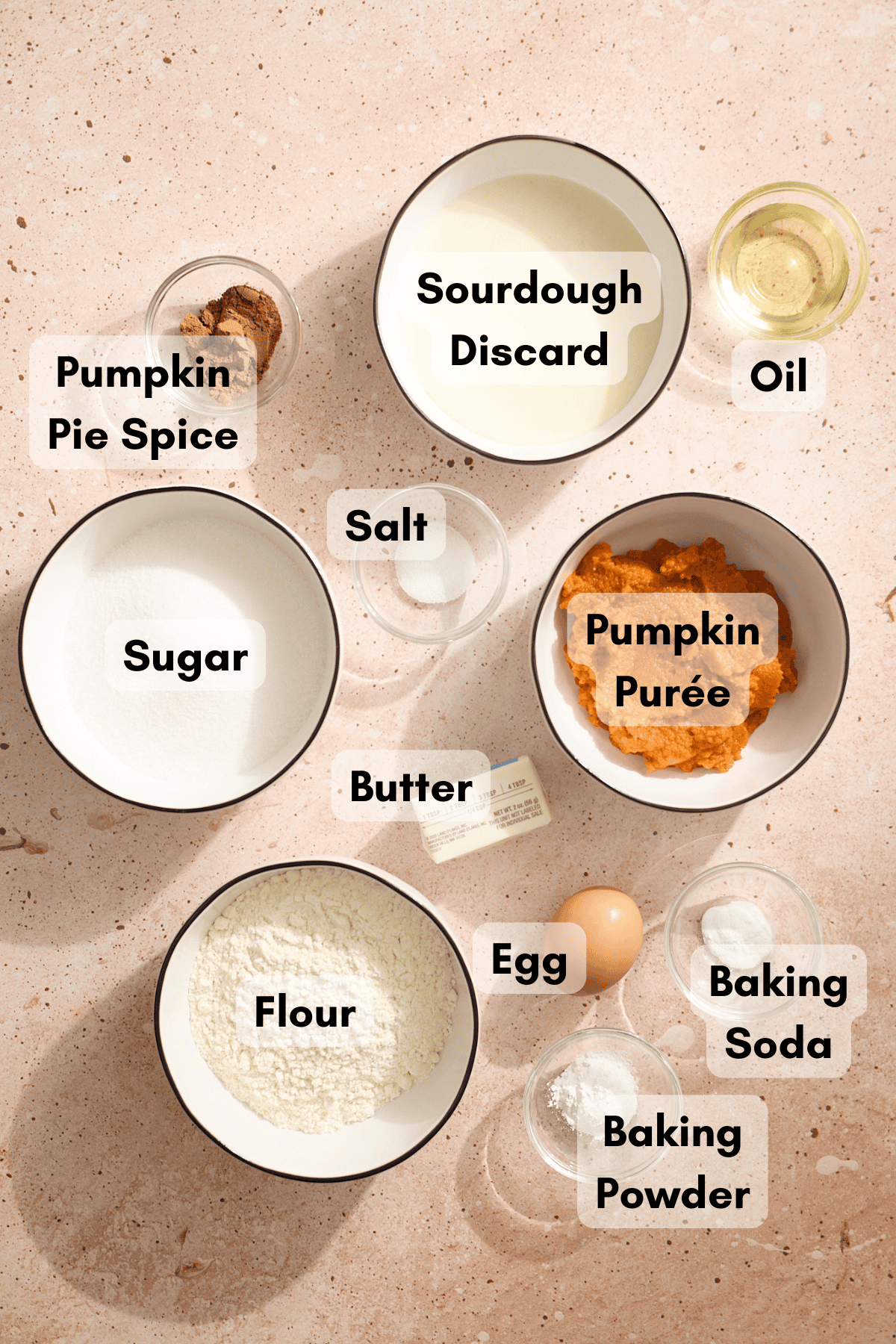 Ingredients for Sourdough Discard Pumpkin Muffins in small bowls. 