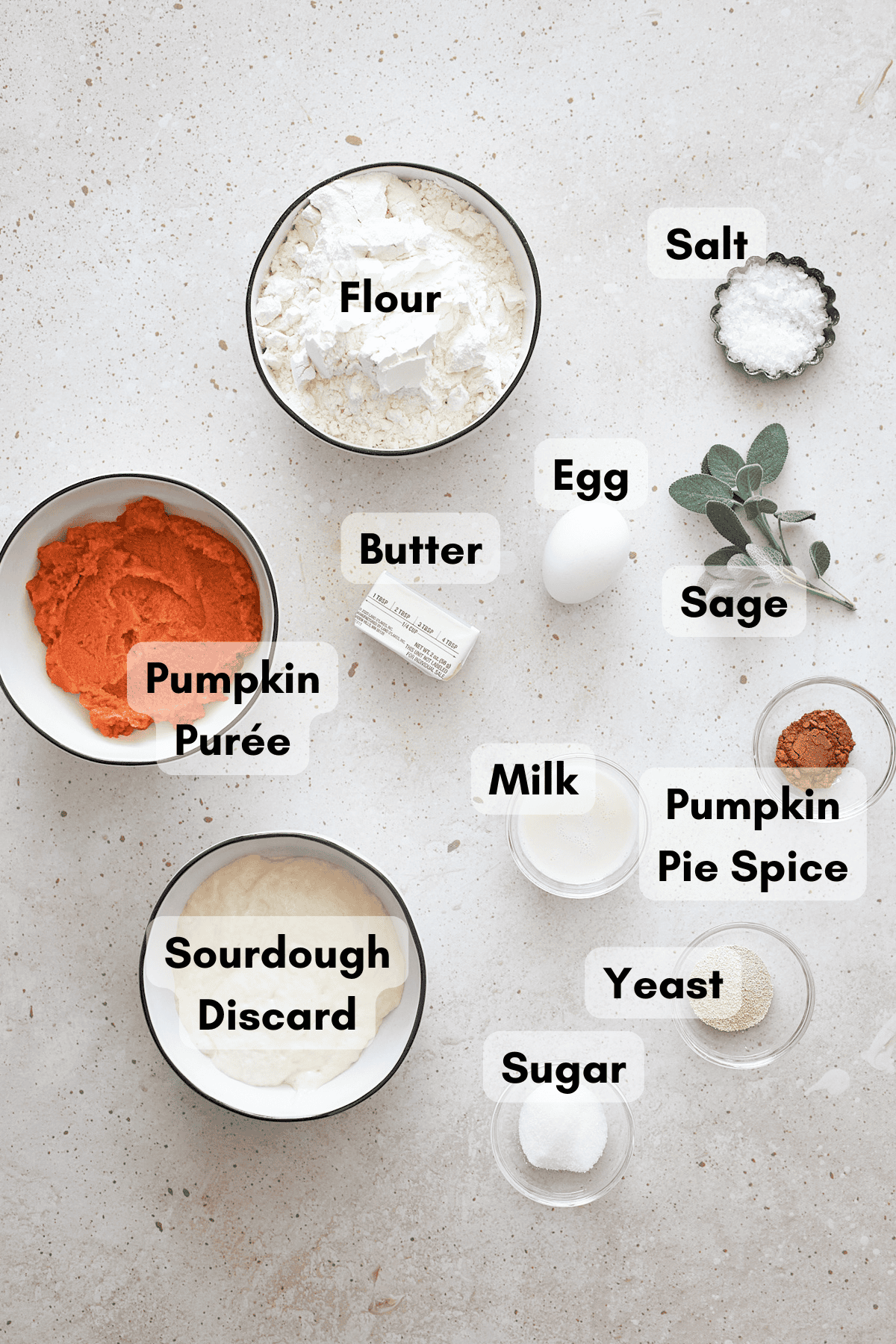 Ingredients for Sourdough Discard Pumpkin Dinner Rolls in small bowls. 