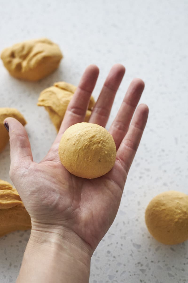 Dinner rolls shaped in the palm of a hand.