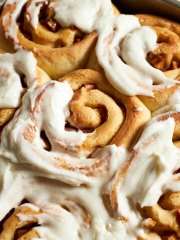 Closeup of Sourdough Discard Apple Cinnamon Rolls with frosting.