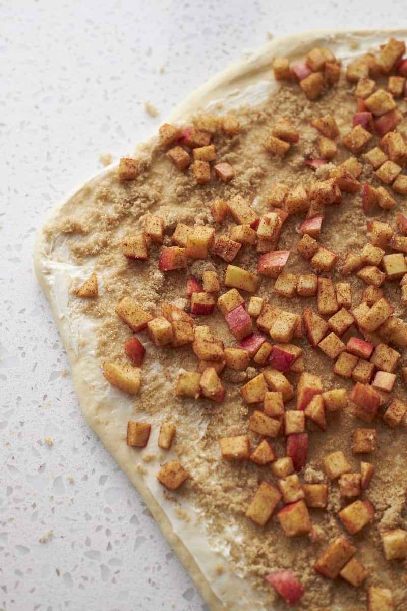 Apples spread on the dough.