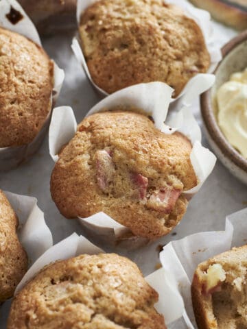 Overhead view of Sourdough Discard Apple Muffins on white parchment paper.