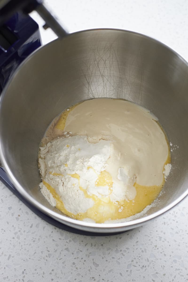 Dough ingredients in the bowl of a stand mixer.