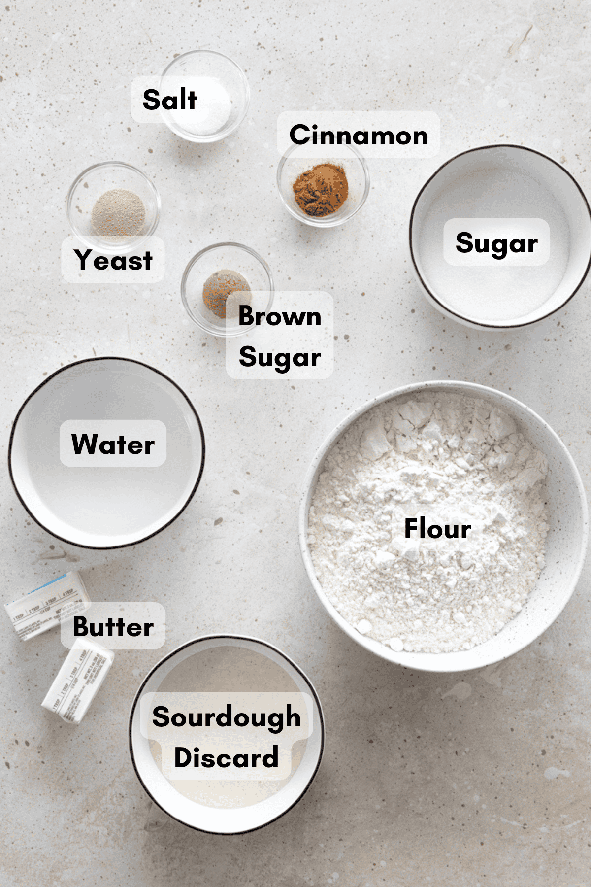 Ingredients for Sourdough Discard Cinnamon Sugar Pretzels in small bowls. 