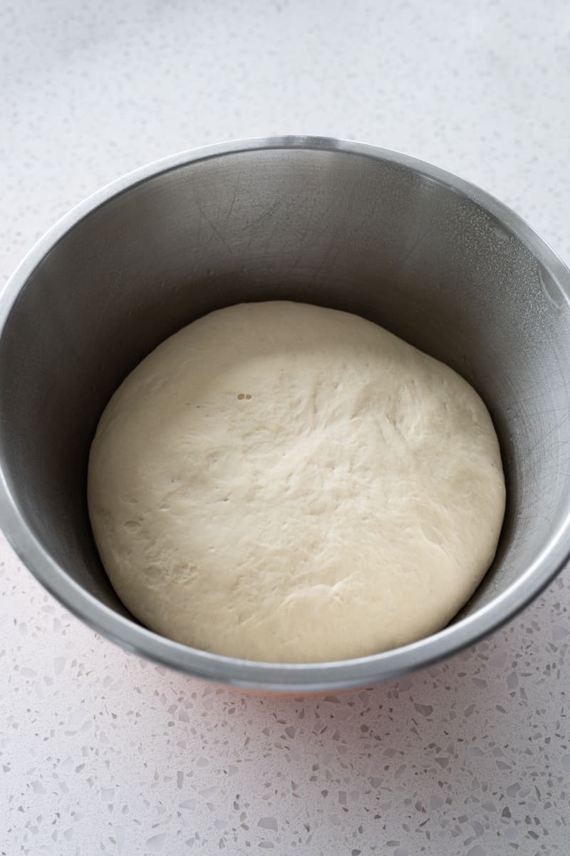 Dough after rising in a large bowl.