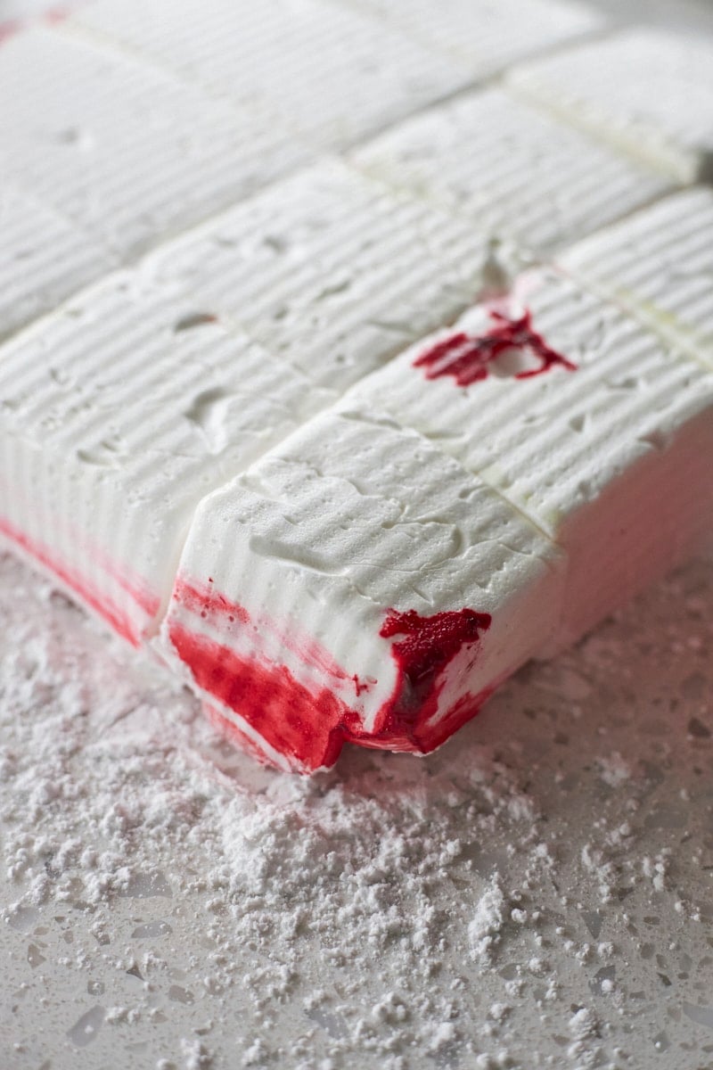 Marshmallows sliced on a work surface.