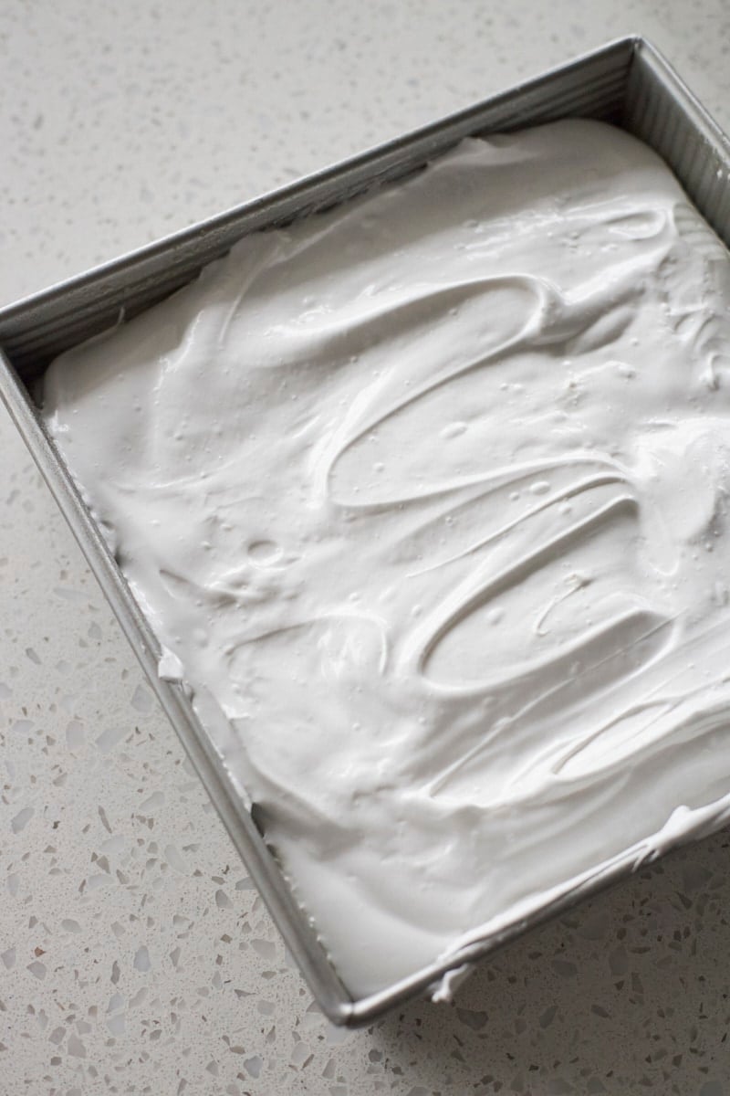 Marshmallows spread in a pan.