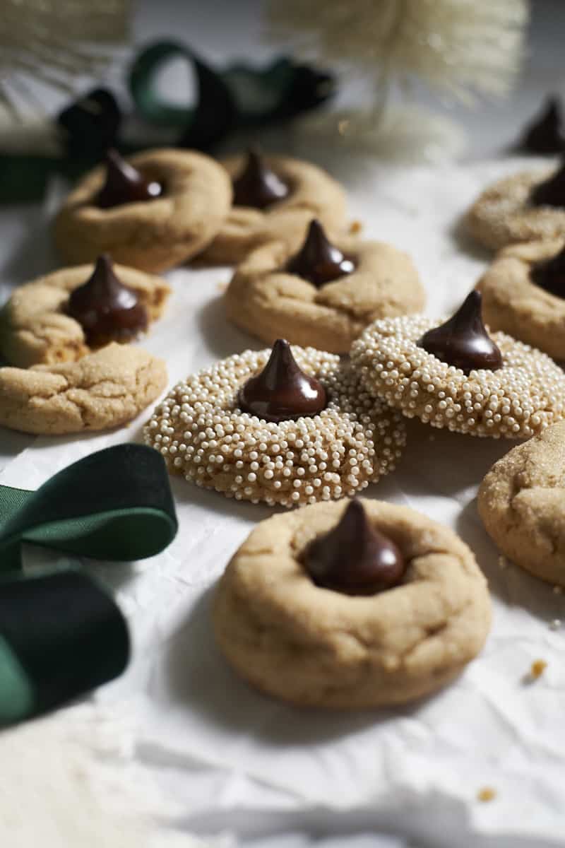 Side view of a pile of Sourdough Discard Peanut Butter Blossoms. 