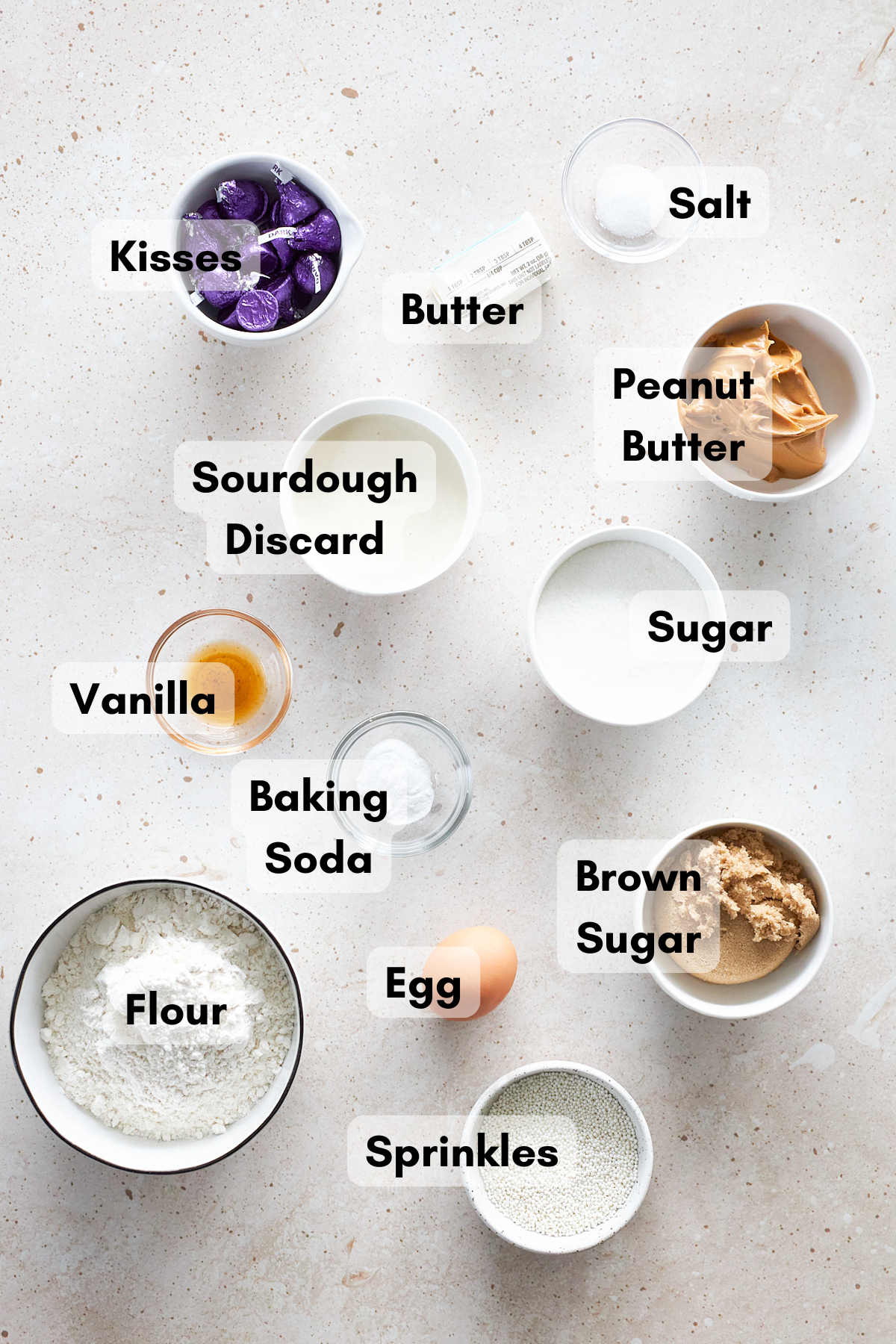 Ingredients for Sourdough Discard Peanut Butter Blossoms in small bowls.