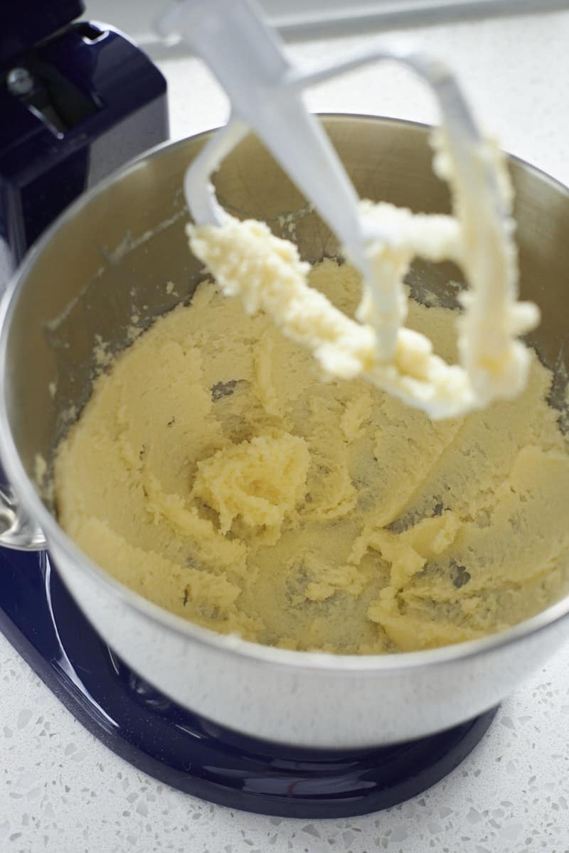 Butter and sugar creamed in the bowl of a stand mixer.