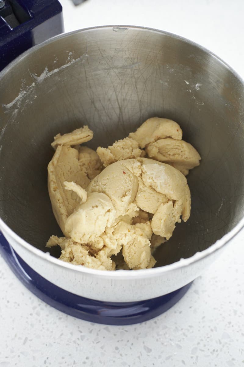 Cookie dough in the bowl of a stand mixer.