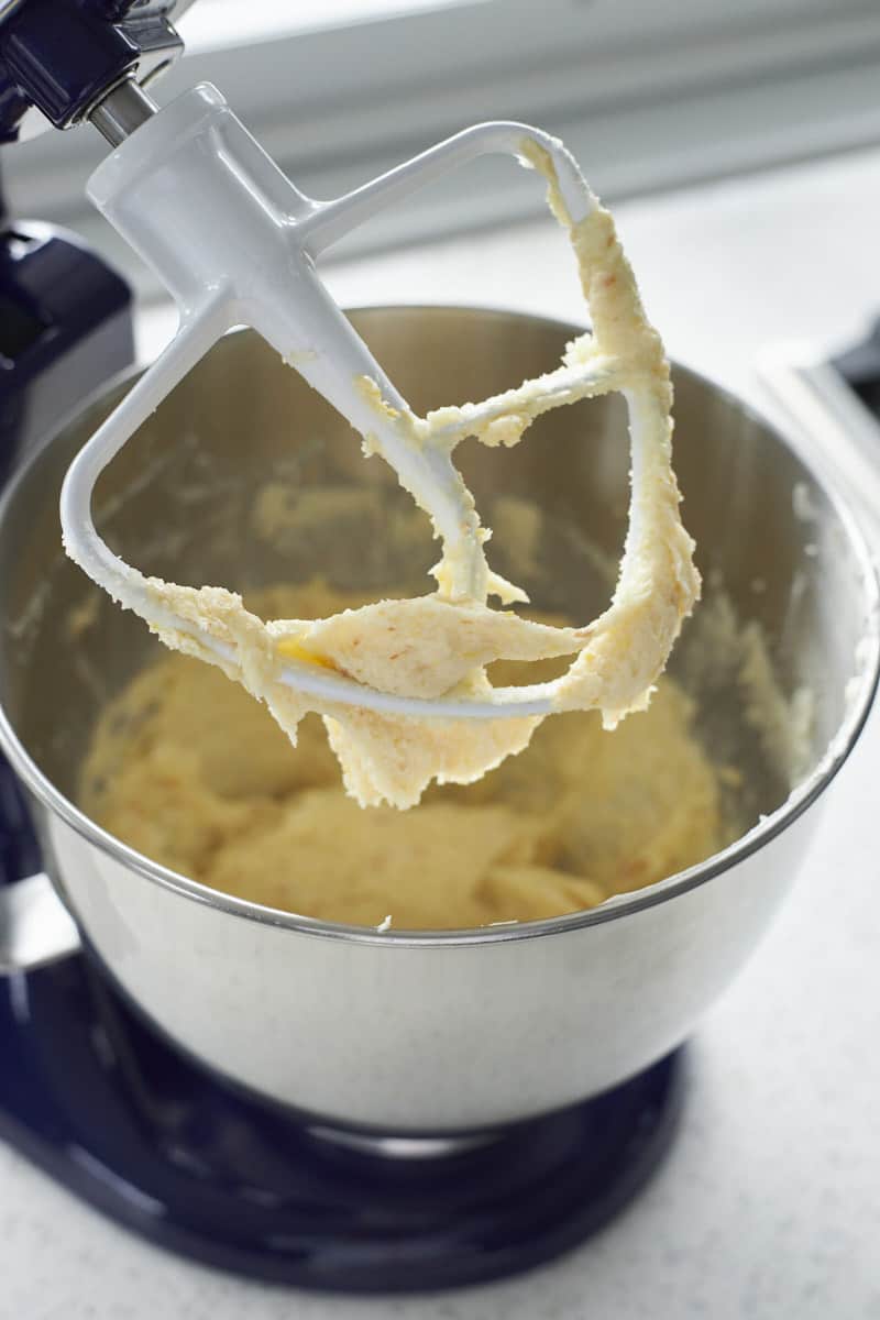 Cookie dough on the paddle attachment of a stand mixer.