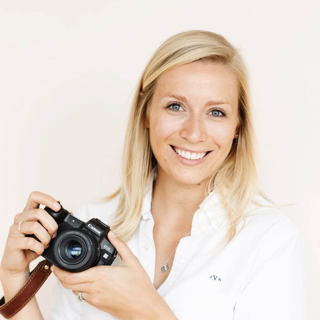 A headshot of Jessica Vogl holding a camera.