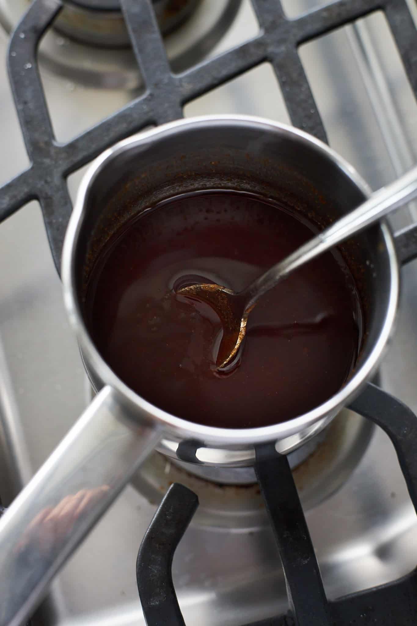 Brown sugar and cinnamon added to melted butter in a small saucepan.