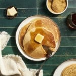 A stack of Sourdough Discard Pancakes with butter and maple syrup.