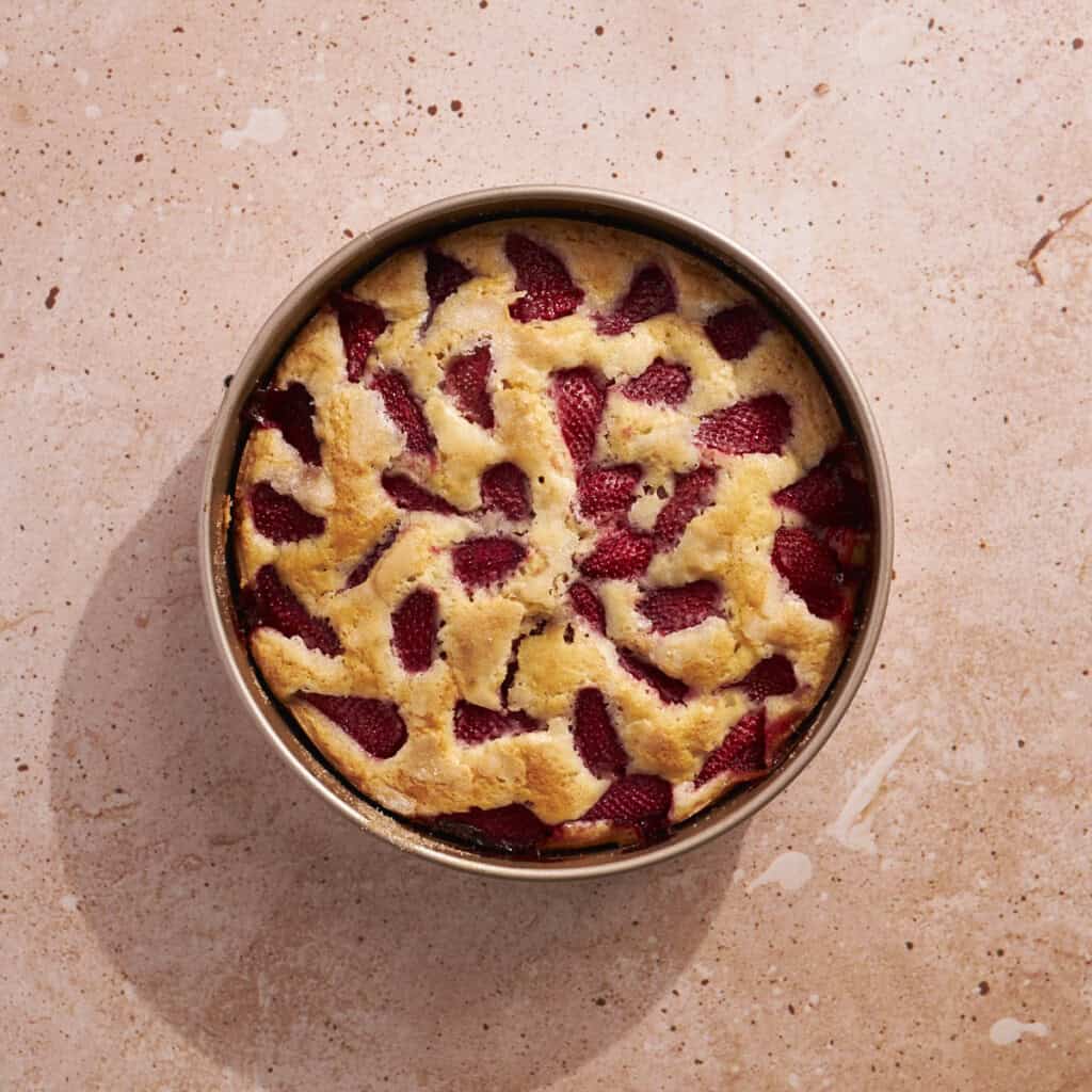 The baked Sourdough Discard Strawberry Cake in a springform pan.