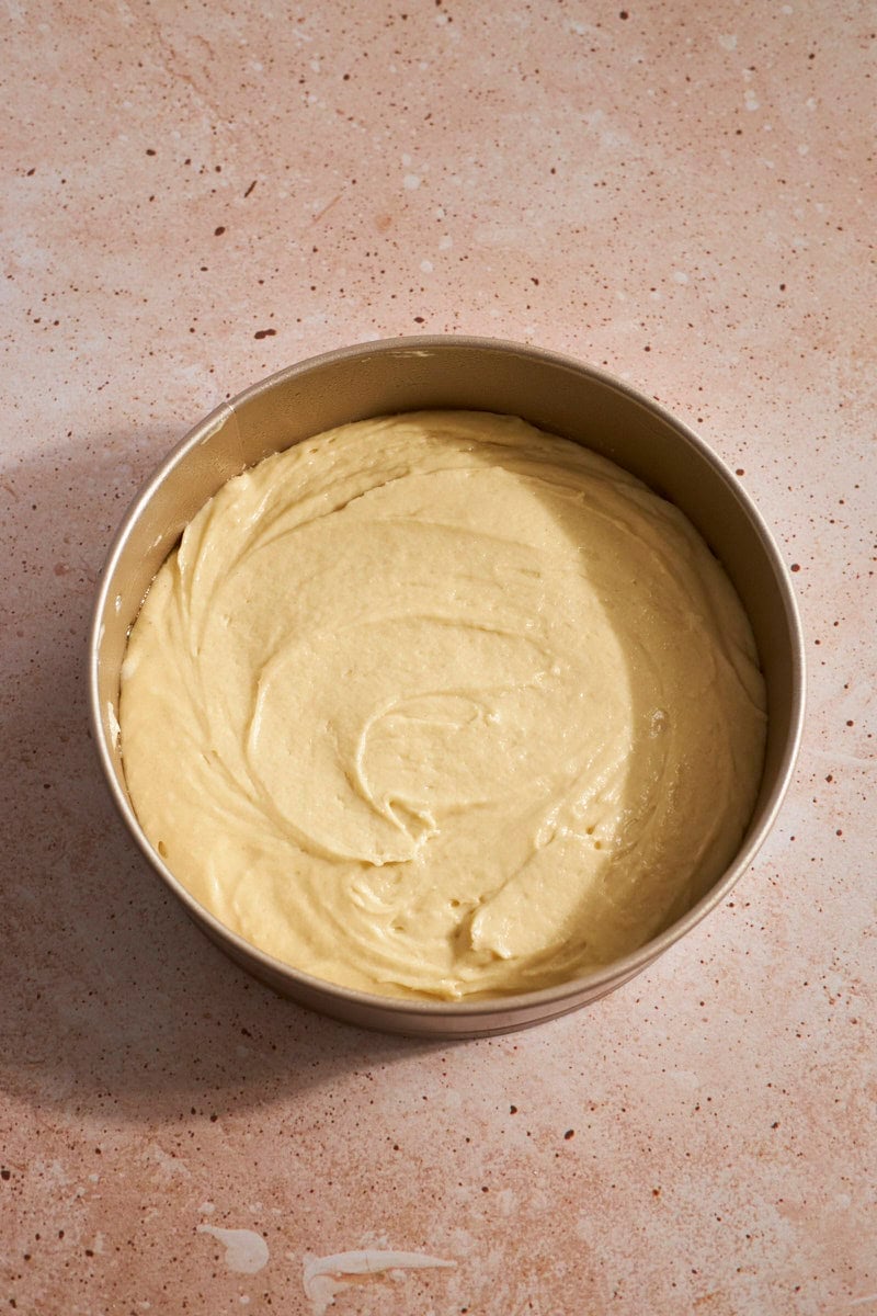 Cake batter spread into the springform pan.