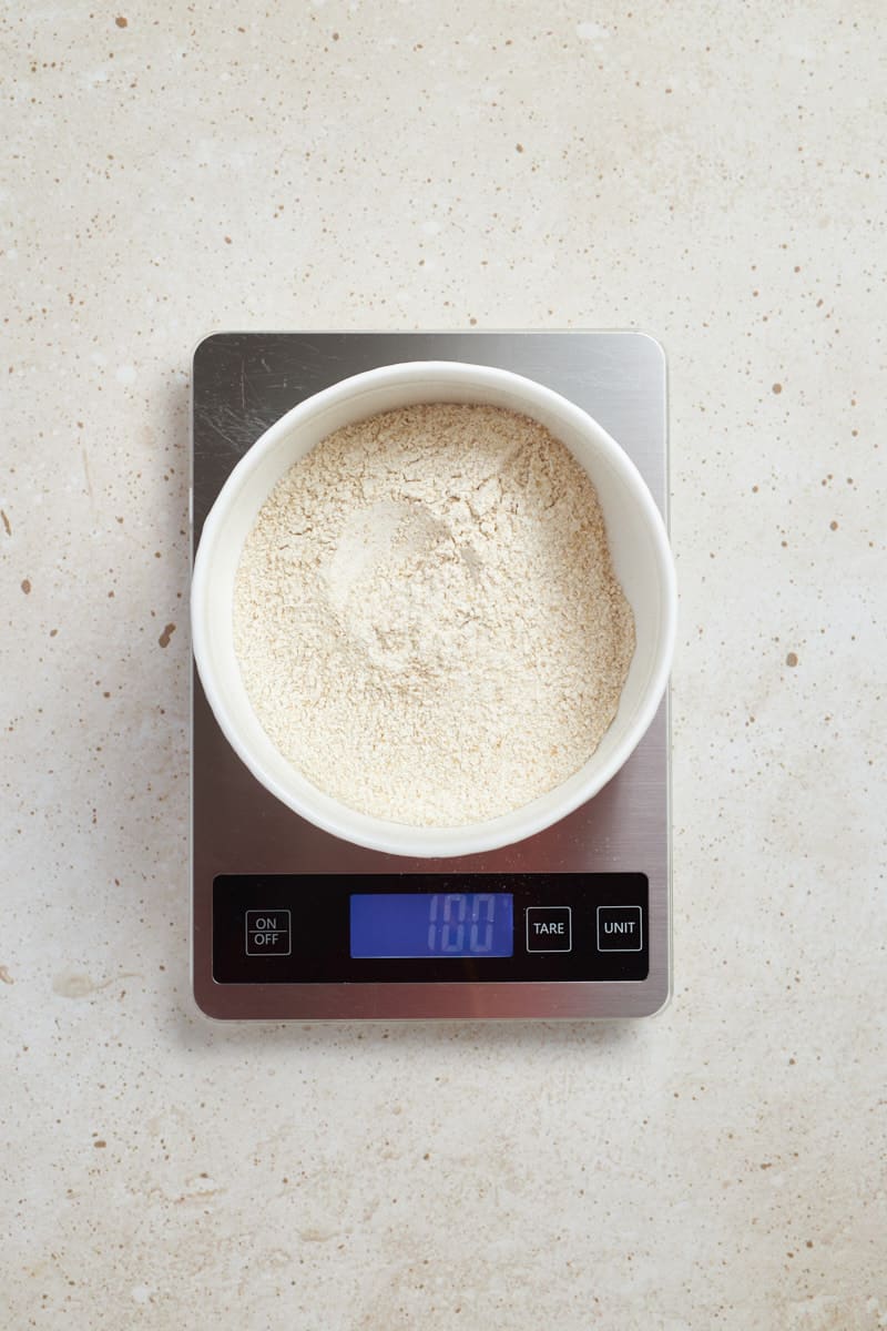 Flour in a bowl on a kitchen scale.