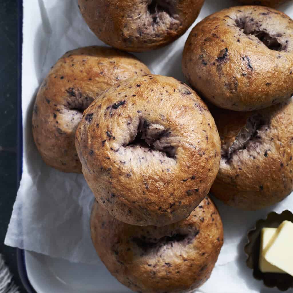 A stack of Sourdough Discard Blueberry Bagels.