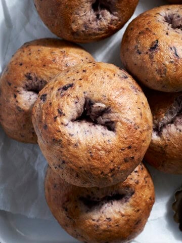 A stack of Sourdough Discard Blueberry Bagels.