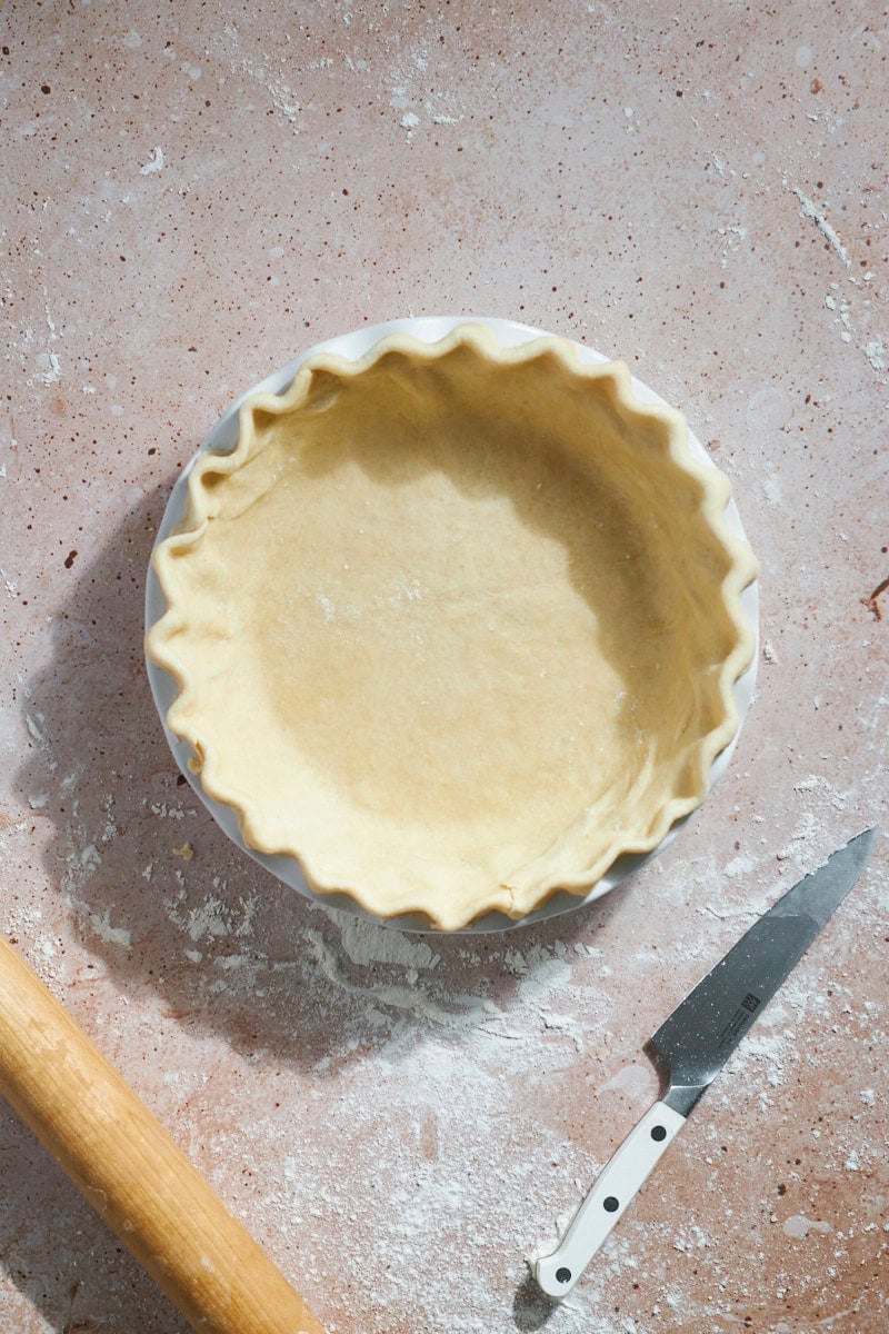 Pie crust shaped and crimped in a pie pan.
