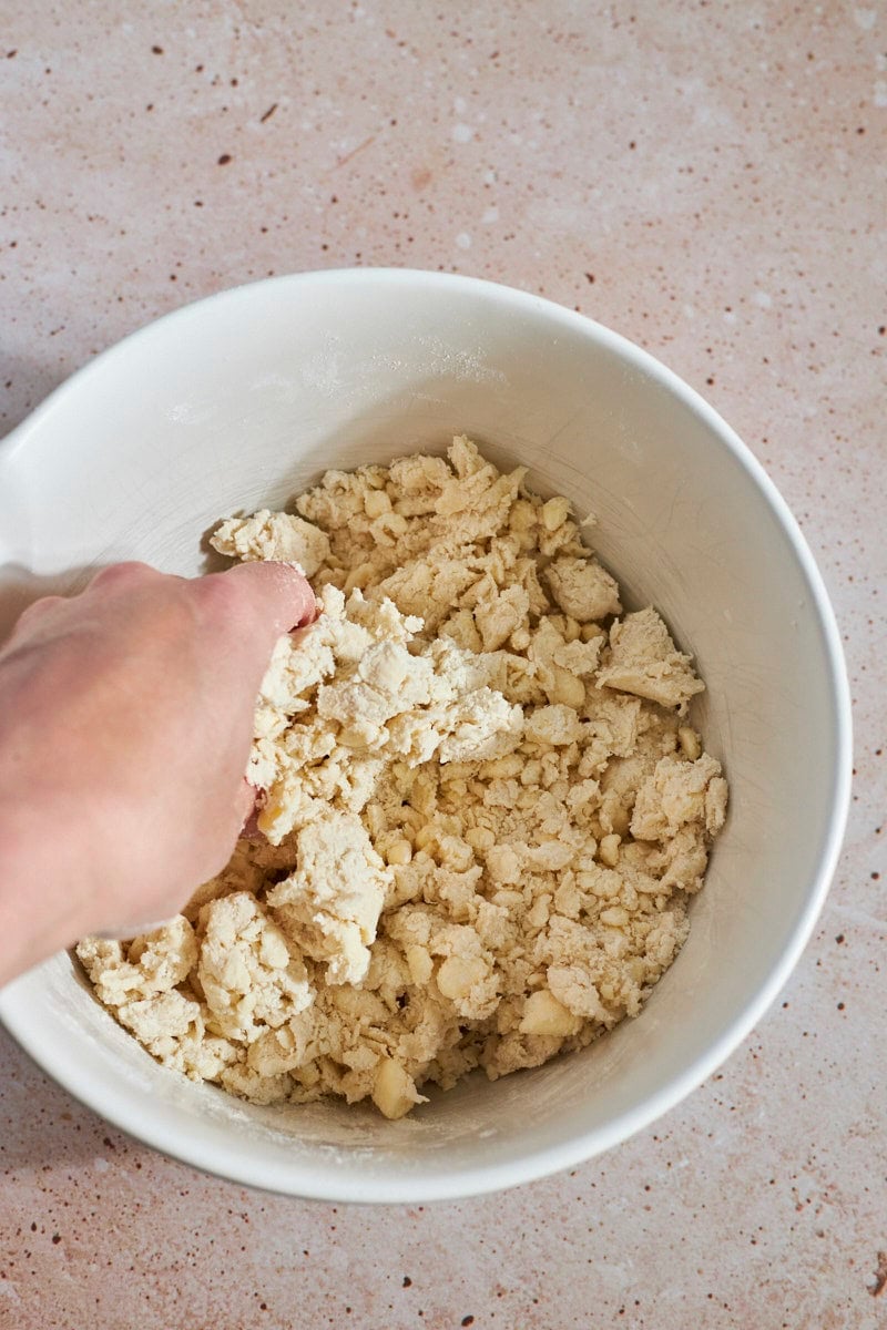 Shaggy, coarse dough mixed in a large bowl.