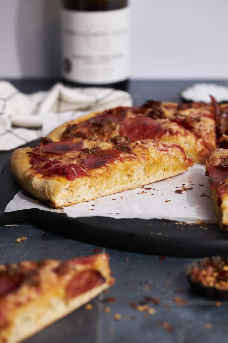 A side view of Sourdough Discard Pizza Dough with thick crust.