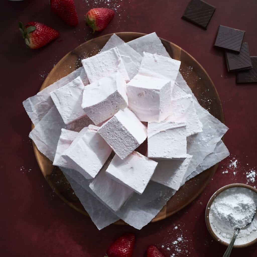 Strawberry Pink Marshmallows on a wooden tray.