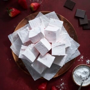 Strawberry Pink Marshmallows on a wooden tray.