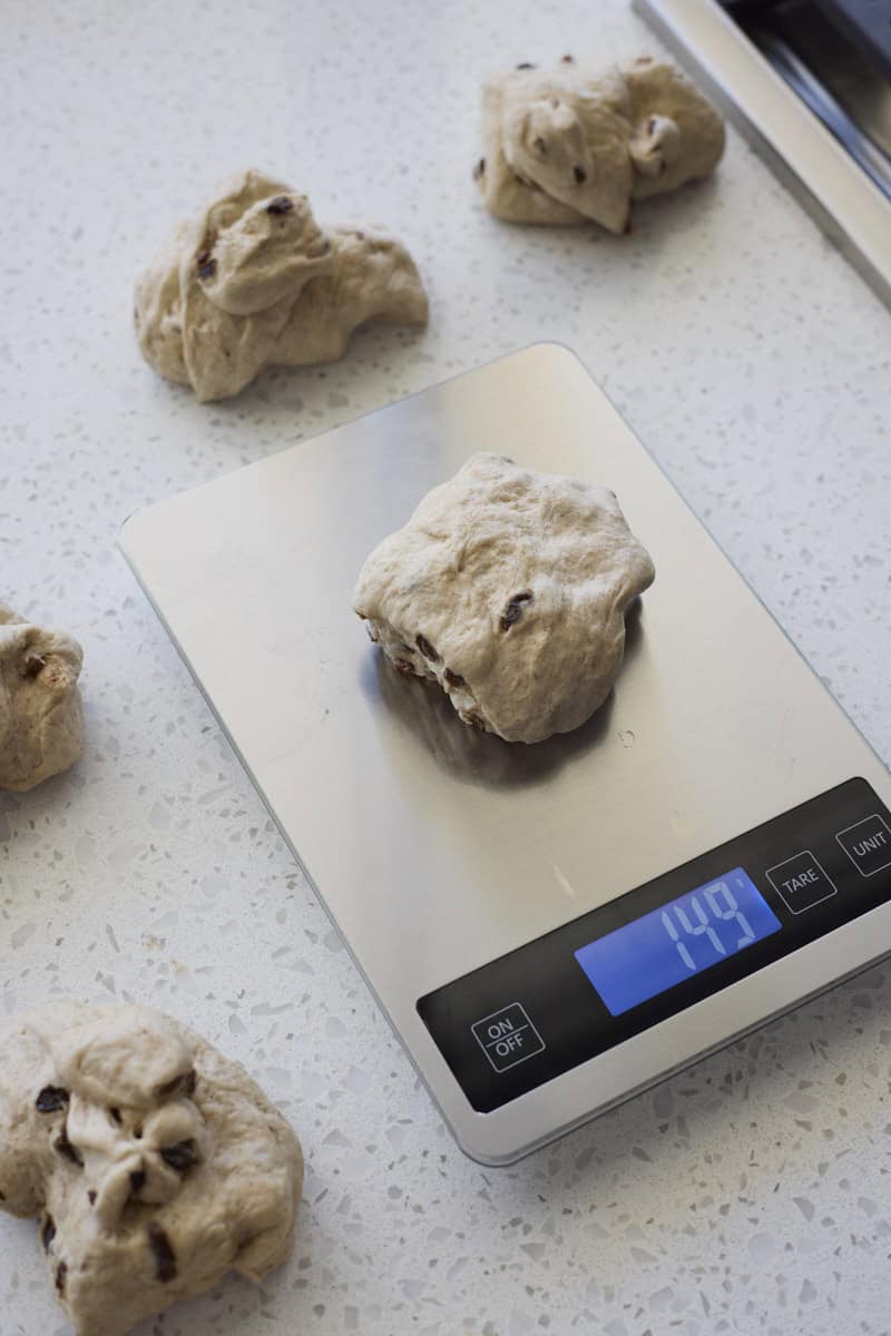 Diving the dough into equal-sized portions on a scale.