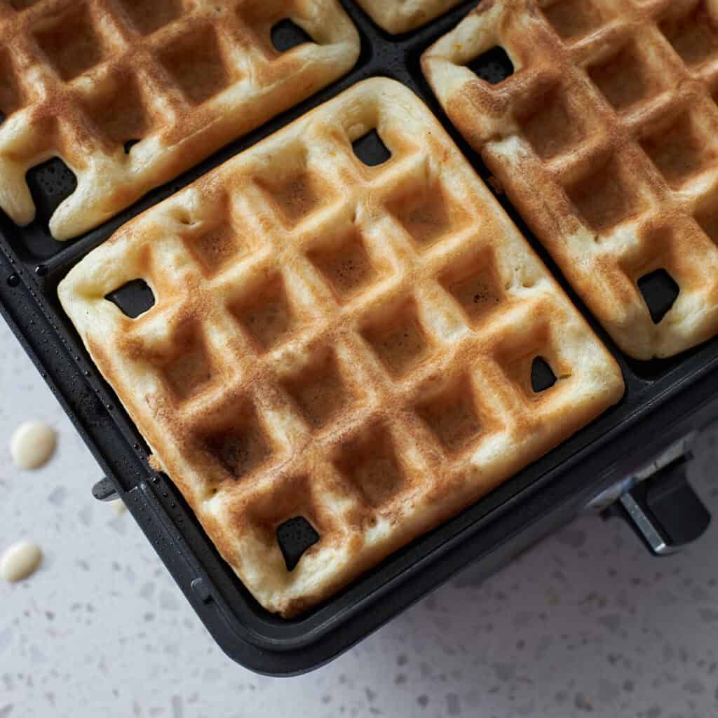 Square waffles in a waffle iron. 