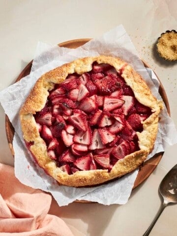 A Sourdough Discard Strawberry Galette on a wooden serving plate.