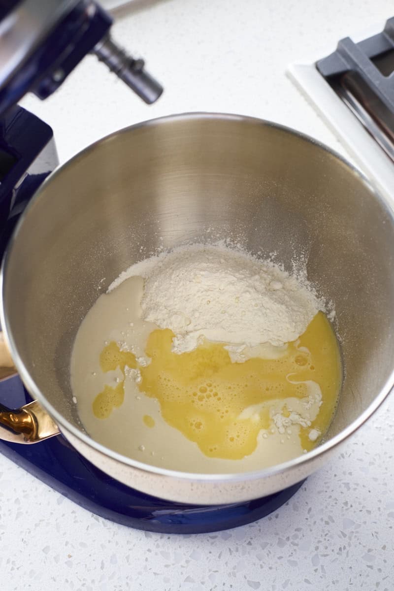 Dough ingredients in the bowl of a stand mixer.